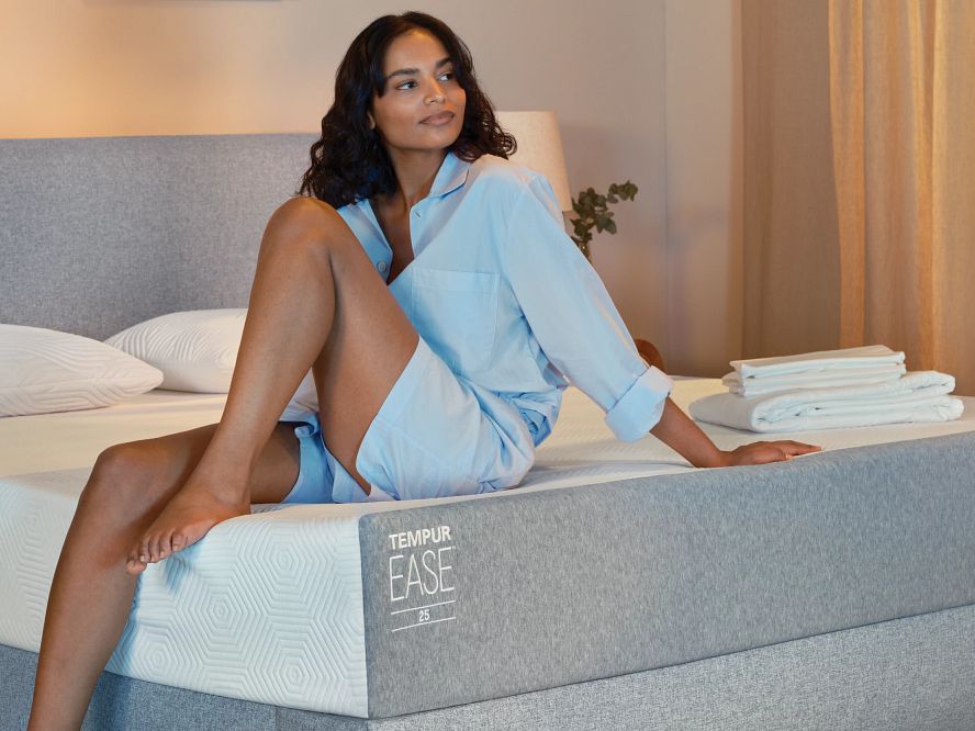 a woman sitting on mattress