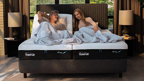 Two people lying on a bed