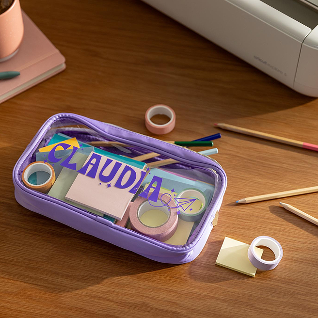 a purple and transparent pencil case with purple lettering that says Claudia