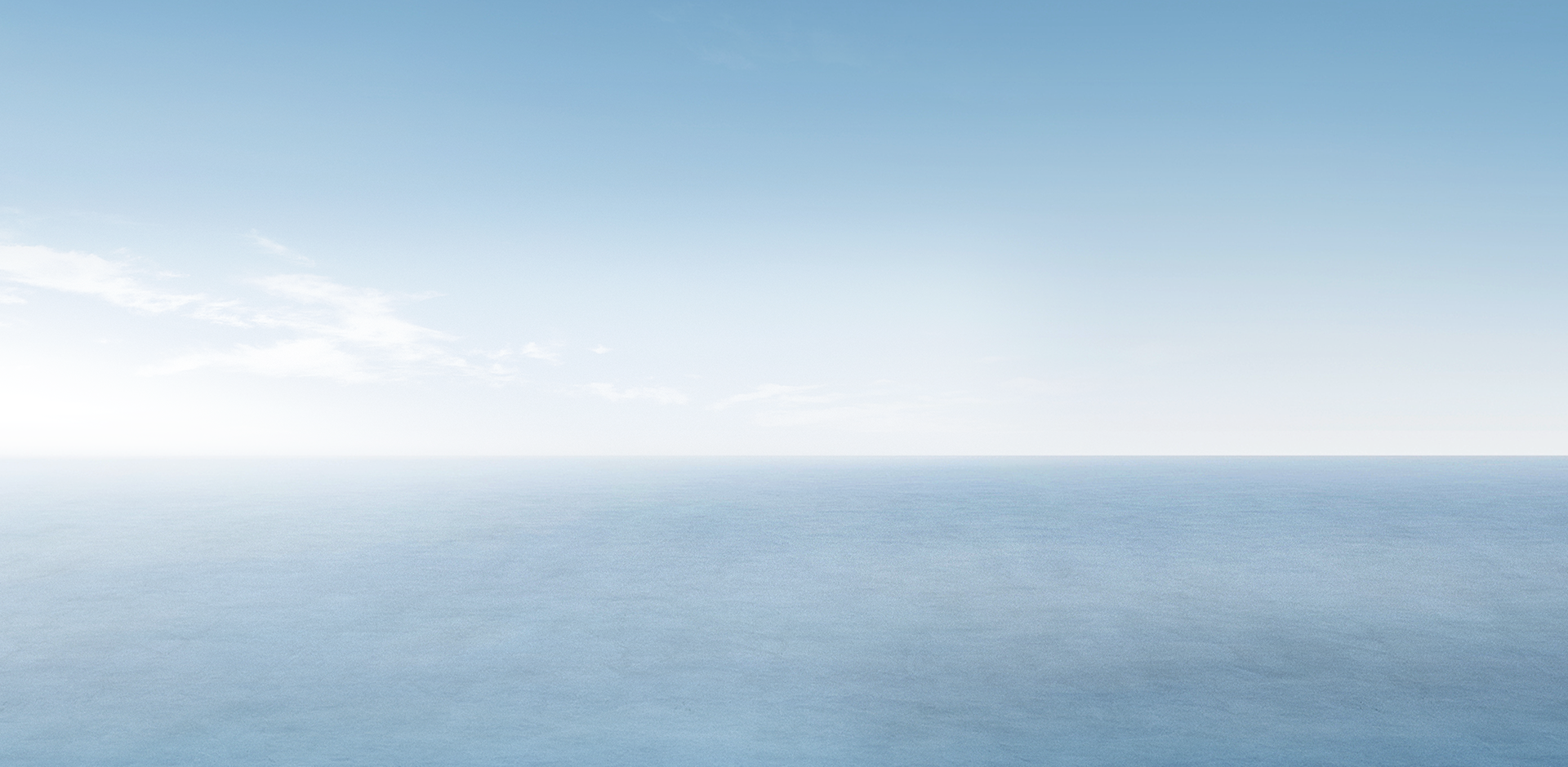 Clear blue sky over calm ocean horizon